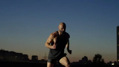 Camera movement from a general plan as an athlete runs in place to a close-up. Stock Footage 247239693