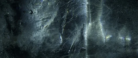 Camera movement on the ice surface on a dark background. Stock Footage 106007611