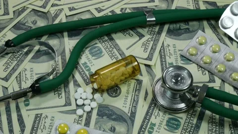 Camera movement over dollars and medicine Video stock 89540965