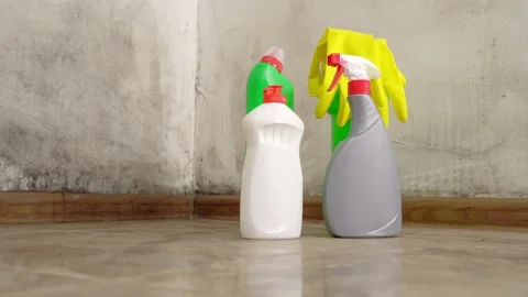 Camera movement on slider. Three bottles stand on floor with yellow gloves Stock Footage 170442314
