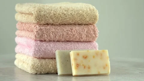 Camera movement on stacked cotton terry towels with soap and sea salt. 스톡 동영상 220286718