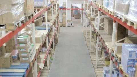 Camera movement from top to bottom along shelves with goods in stock Video stock 102396816