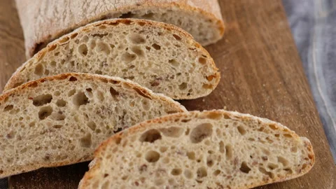 Camera movement. Top view. Sliced bread lies on a wooden board. Baking bread Stock Footage 145492520