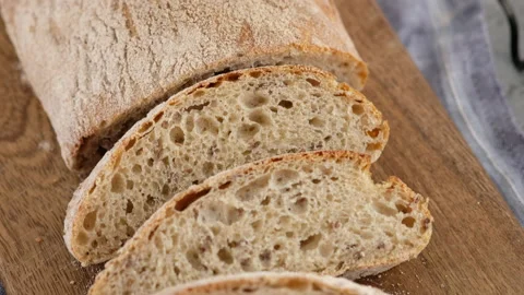 Camera movement. Top view. Sliced bread lies on a wooden board. Baking bread Stock Footage 146905900