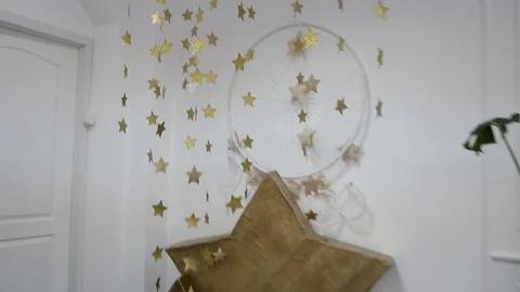 Camera movement in a white room decorated with golden asterisks Stock Footage 92331081