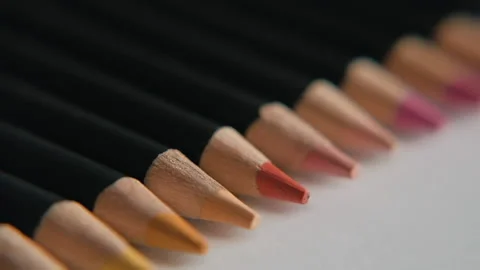Camera moves above rows of colored pencils. Slow motion macro shot. Stock Footage 130796419