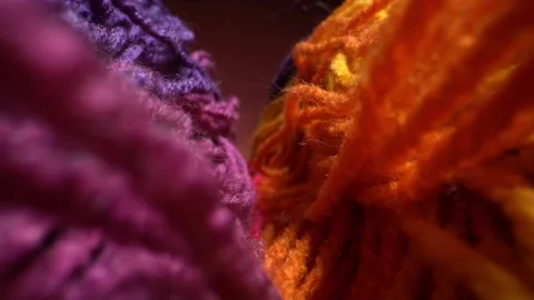 Camera moves above rows of colored woolen threads for knitting. Wool texture Stock Footage 141949877