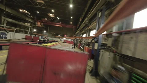 Camera moves across production floor highlighting labyrinth of workstations Stock Footage 304412366