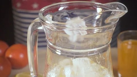 The camera moves after the ice falling into the carafe slow motion Stock Footage 88049775