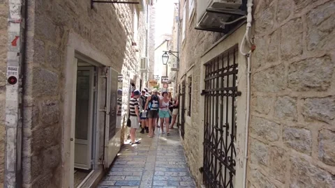 The camera moves ahead in the narrow Petra I Petrovića Street in Budva Old Town Stock Footage 249415196