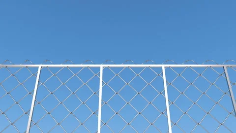 The camera moves along the barbed wire fence against the sky. Stock Footage 128303387