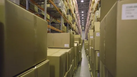 Camera moves along boxes in warehouse Stock Footage 76026793
