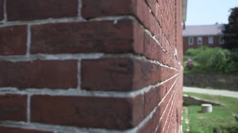 The camera moves along a brick wall of a house or home. Stock Footage 55460751