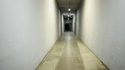 The camera moves along a dark corridor of an industrial building Stock Footage 165394781