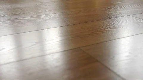 The camera moves along the floor, covered with laminated parquet with a brown Stock Footage 85400268