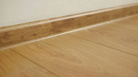 The camera moves along the floor, covered with laminated parquet with a brown Stock Footage 85400628