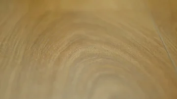 The camera moves along the floor, covered with laminated parquet with a brown Stock Footage 85575794