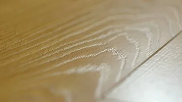 The camera moves along the floor, covered with laminated parquet with a brown Stock Footage 85576011