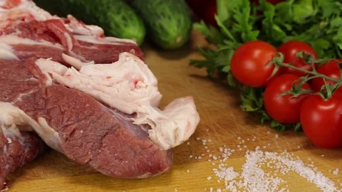 The camera moves along a large piece of raw meat Stock Footage 122171287