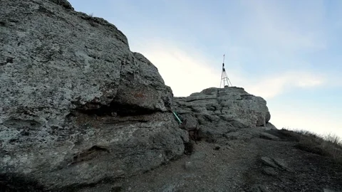 Camera moves along a mountain path among the stones on the way to the tower Video stock 170021779