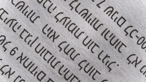 Camera moves along a newspaper sheet in Hebrew, macro view, slider moving Stock Footage 126758763