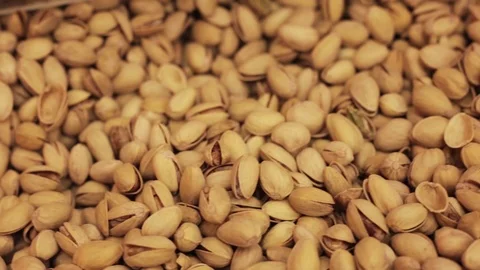 Camera moves along of pistachios nut Close up on the counter in the shop Stock Footage 112854597