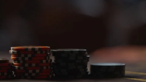 The camera moves along the poker chips on the table. Gaming industry Stock Footage 252214594
