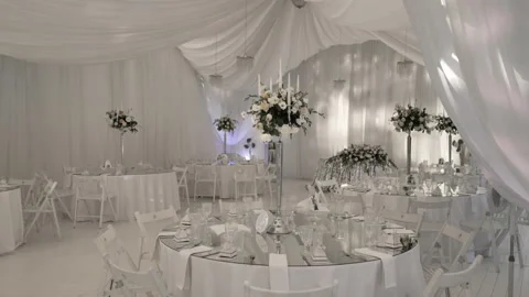 The camera moves along the round glass tables at the wedding banquet Stock Footage 201013123