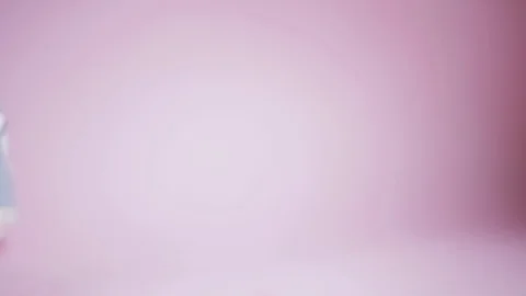 The camera moves along the sporting children's denim shoes standing on pink Stock Footage 112631223