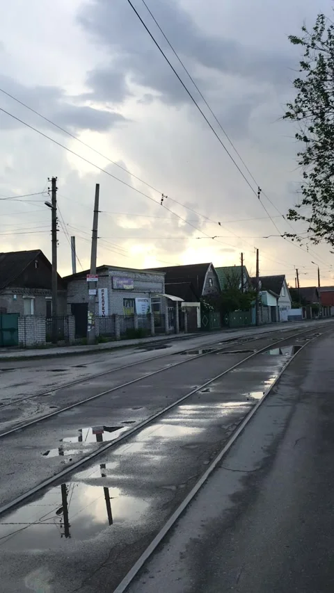 Camera moves along the tram tracks along the old roads of a small town Stock Footage 241181093