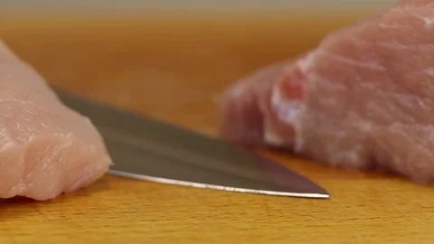 The camera moves along two pieces of raw pork Stock Footage 122133683