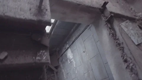 Camera moves along upstairs in empty building destroyed by earthquake. POV shot Video stock 80311377