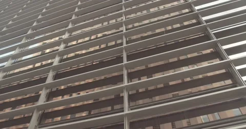 Camera moves along the wall of an office building in the evening at sunset Stock Footage 168893528