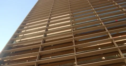 Camera moves along the wall of an office building in the evening at sunset Stock Footage 232336070