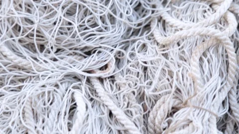 Camera moves along the white old tangled fishing net close-up Stock Footage 109607102