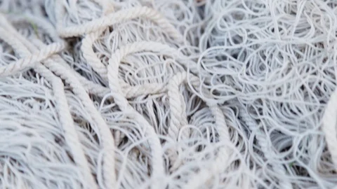 Camera moves along the white old tangled fishing net close-up Stock Footage 109607230