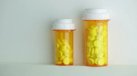 Camera moves up and stops on the bottles of pills Stock Footage 62184246