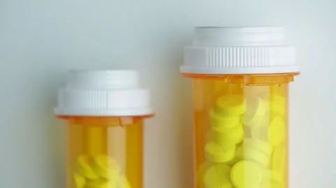 Camera moves up and stops on the bottles of pills Stock Footage 62184275