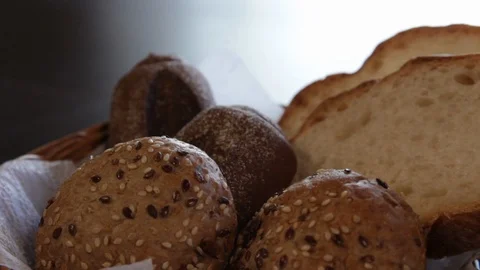 The camera moves around the basket with several kinds of bread. close-up Stock Footage 114703836