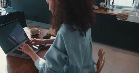 Camera moves around beautiful happy young multiethnic web developer woman using Stock Footage 148642646