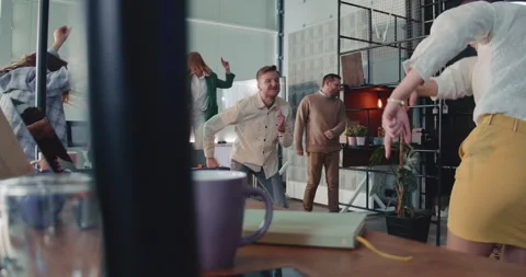 Camera moves around crazy office party, happy business people celebrating raise Stock Footage 217423741