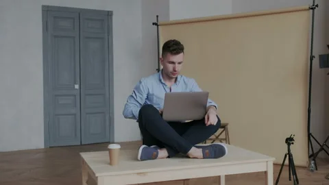 Camera moves around creative businessman while he sitting in the lotus position Stock Footage 107784237