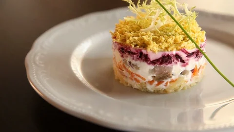 Camera moves around a plate with Herring under a fur coat at restaurant.Close-up Stock Footage 123709974