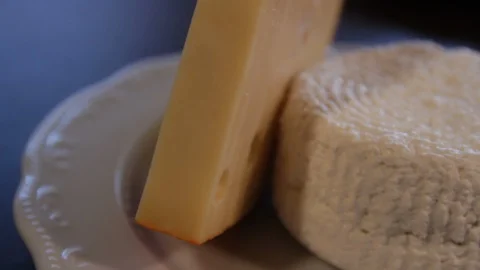 The camera moves around the plate on the table with Emmental and Adygei cheese. Stock Footage 112538104