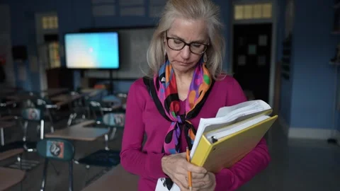 Camera Moves Around Sad Frustrated Mature Woman Teacher in Empty Classroom in a Stock Footage 301895673