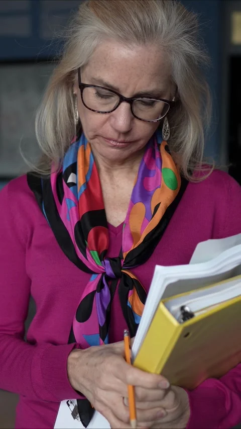 Camera Moves Around Sad Frustrated Mature Woman Teacher in Empty Classroom in a Stock Footage 306312582