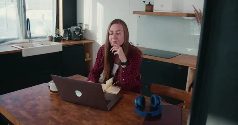 Camera moves around young focused beautiful Caucasian freelancer business woman Stock Footage 148500932