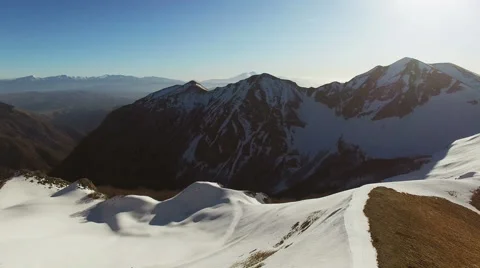 The camera moves away from the mountains with snow N. Stock Footage 63430752