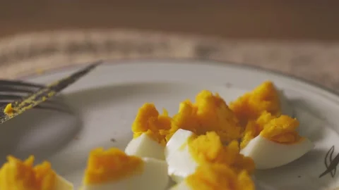 Camera moves back over plate with hard boiled egg Stock Footage 136655275