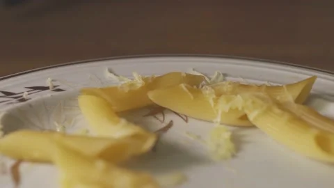 Camera moves back over a white plate with left overs of pasta with cheese Video stock 136655261